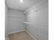Walk-in closet with a neutral carpet and white wire shelving. Plenty of room to store clothes and shoes at 1713 Real St, Indianapolis, IN 46240