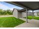 View of back of home with green grass and covered patio at 1717 Real St, Indianapolis, IN 46240