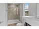 Bathroom with a fully-tiled shower, bright natural light, and modern fixtures at 1717 Real St, Indianapolis, IN 46240