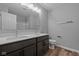 Modern bathroom featuring double sinks, a large mirror, and updated lighting at 1717 Real St, Indianapolis, IN 46240