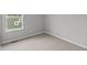 Bedroom with neutral carpeting and window overlooking backyard at 1717 Real St, Indianapolis, IN 46240