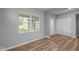 Cozy bedroom featuring neutral walls, hardwood flooring, and a large window at 1717 Real St, Indianapolis, IN 46240