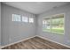The bright bedroom features three large windows and hardwood flooring at 1717 Real St, Indianapolis, IN 46240