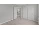 Bedroom with plush carpeting, closet with sliding doors, and open door to hallway at 1717 Real St, Indianapolis, IN 46240