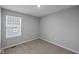 Bedroom has a window with blinds, neutral walls, and carpet at 1717 Real St, Indianapolis, IN 46240