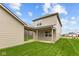 Exterior elevation of home shows covered back patio and neutral vinyl siding at 1717 Real St, Indianapolis, IN 46240