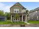 Charming two-story home featuring stone accents, well-kept lawn, and a welcoming front porch at 1717 Real St, Indianapolis, IN 46240