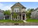 Charming two-story home featuring stone accents, well-kept lawn, and a welcoming front porch at 1717 Real St, Indianapolis, IN 46240