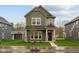 Two-story home showcasing an inviting covered front porch and a well-manicured lawn at 1717 Real St, Indianapolis, IN 46240