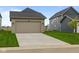 Two-car garage with driveway and manicured lawn at 1717 Real St, Indianapolis, IN 46240