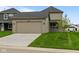 Two-car garage with driveway and manicured lawn at 1717 Real St, Indianapolis, IN 46240