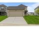 Two-car garage with driveway and manicured lawn at 1717 Real St, Indianapolis, IN 46240