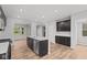 Modern kitchen features an island with stainless steel appliances and dark cabinetry at 1717 Real St, Indianapolis, IN 46240