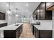 Modern kitchen with a large island, stainless steel appliances, and stylish pendant lighting at 1717 Real St, Indianapolis, IN 46240