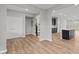 Open living room and kitchen with stainless steel appliances, a center island, and wood-look flooring throughout at 1717 Real St, Indianapolis, IN 46240