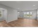 Spacious open-concept living room with wood-look floors, recessed lighting, and large windows for lots of natural light at 1717 Real St, Indianapolis, IN 46240