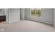 Cozy bedroom with plush carpeting, an ensuite bathroom, and a large window for natural light at 1717 Real St, Indianapolis, IN 46240