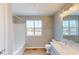 Bathroom featuring a window over the toilet, a tub with a shower, and a vanity with sink at 1721 Real St, Indianapolis, IN 46240