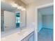 Bathroom vanity with modern faucet and lighting, offering a view to a tile lined shower at 1721 Real St, Indianapolis, IN 46240