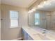 A spacious bathroom featuring double sinks, modern fixtures, and natural light from two windows at 1721 Real St, Indianapolis, IN 46240