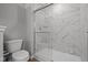 Bathroom with shower featuring glass doors and marble styled tile at 1721 Real St, Indianapolis, IN 46240