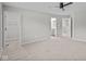 Spacious bedroom with neutral carpet, ceiling fan, walk-in closet, and an attached bathroom at 1721 Real St, Indianapolis, IN 46240