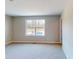 A well-lit bedroom featuring a large window with a view of the outdoors and neutral-toned walls at 1721 Real St, Indianapolis, IN 46240
