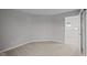 Carpeted room featuring neutral walls and a door leading to additional rooms at 1721 Real St, Indianapolis, IN 46240