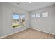 Bright bedroom features wood flooring, large windows, and neutral paint, creating a serene and inviting space at 1721 Real St, Indianapolis, IN 46240