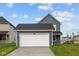 Traditional two-story home with attached two-car garage and dark gray siding at 1721 Real St, Indianapolis, IN 46240
