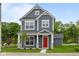 Charming two-story home with a red front door, gray siding, white trim, and manicured lawn at 1721 Real St, Indianapolis, IN 46240