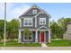 Charming two-story home with a red front door, gray siding, white trim, and manicured lawn at 1721 Real St, Indianapolis, IN 46240