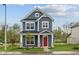 Charming two-story home featuring a striking red door, stone accents, and beautiful curb appeal at 1721 Real St, Indianapolis, IN 46240