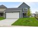A beautiful home with a spacious garage, healthy green grass, and an inviting driveway at 1721 Real St, Indianapolis, IN 46240