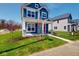 Beautiful two-story home showcasing blue siding, white trim, a red front door, and a lush green lawn at 1721 Real St, Indianapolis, IN 46240