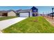 Attached two-car garage showcasing the home's exterior and manicured landscaping at 1721 Real St, Indianapolis, IN 46240