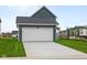 Home with a spacious garage and driveway, complemented by manicured grass and neighborhood views at 1721 Real St, Indianapolis, IN 46240