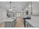 Modern kitchen with stainless steel appliances, subway tile backsplash, and an island with pendant lighting at 1721 Real St, Indianapolis, IN 46240