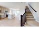 Open-concept kitchen and staircase with stainless steel appliances and modern finishes at 1721 Real St, Indianapolis, IN 46240