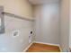 Practical laundry room with wood-look flooring, shelving, and washer/dryer hookups at 1721 Real St, Indianapolis, IN 46240