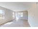 Sunlit living room with neutral walls, recessed lighting, and beautiful modern flooring at 1721 Real St, Indianapolis, IN 46240