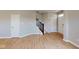 View of the home's entryway showing the staircase and light wood flooring in the living room at 1721 Real St, Indianapolis, IN 46240