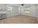 Open living room with wood flooring, neutral paint, and multiple windows for natural light and backyard view at 1721 Real St, Indianapolis, IN 46240