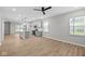 Open-concept living space features wood floors, neutral paint, a kitchen island, and a ceiling fan at 1721 Real St, Indianapolis, IN 46240