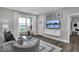 Relaxing living room with hardwood floors, a large TV, and access to other rooms at 19544 Allenwood Dr, Westfield, IN 46074
