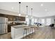 Modern kitchen with dark brown cabinets, granite counters, and island at 2136 Sugar Grove Ave, Indianapolis, IN 46202