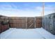 Private backyard with wooden fence and snowy ground at 2634 Country Estates Dr # 17, Indianapolis, IN 46227