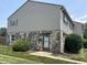 Two-story townhouse with stone facade, horizontal siding and manicured lawn and shrubs at 2634 Country Estates Dr # 17, Indianapolis, IN 46227