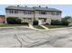 Two-story townhomes featuring stone and siding exteriors and well-maintained landscaping at 2634 Country Estates Dr # 17, Indianapolis, IN 46227