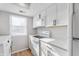 White kitchen with stainless steel appliances and quartz countertops at 2634 Country Estates Dr # 17, Indianapolis, IN 46227